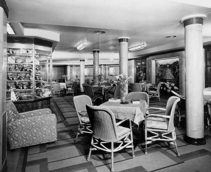 The Third Class Garden Lounge looking to port on board the Cunard Line ocean liner RMS Queen Mary