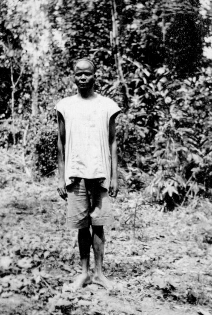 Cameroonian in a clearing in the jungle with a camp fire