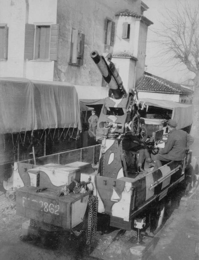 Anti-aircraft gun mounted on the back of a truck in Italy