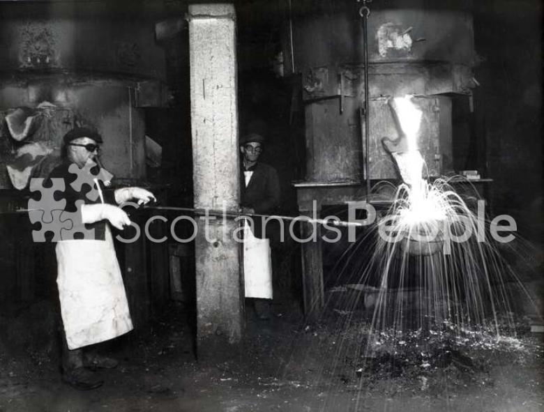 Workmen filling ladle at Carron Works, 20th century