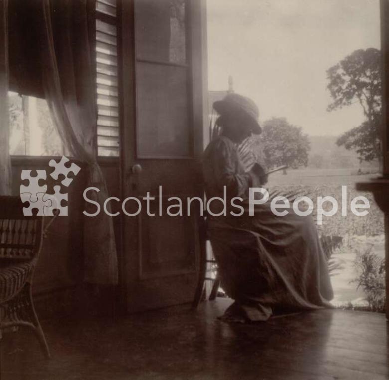 Woman sitting at open doorway, 1905