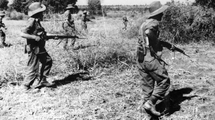 British soldiers advancing through countryside in South East Asia, c 1944-1945