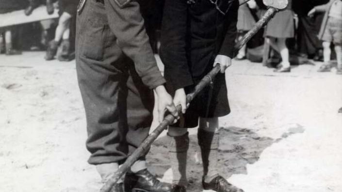 Soldier and boy with mine detector, 1944