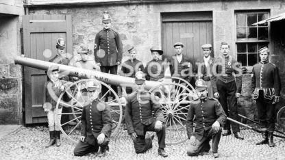 Volunteer firemen and estate workers with a pump mounted on wheels, c 1905 Volunteer firemen and estate workers with a pump mounted on wheels, c 1905