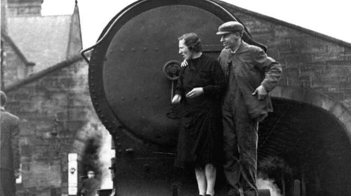 Couple on front footplate of locomotive, 1943