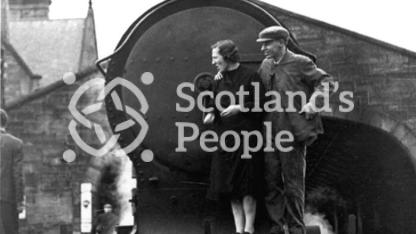 Couple on front footplate of locomotive, 1943 Couple on front footplate of locomotive, 1943