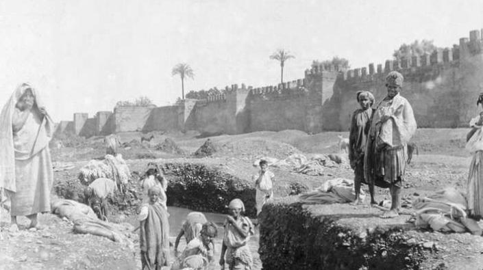 Washing by Marrakech walls, c 1890
