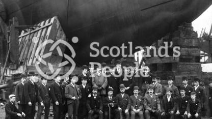 Staff of J & G Thomson posing before the bow of HMS Ramilies on the slip way on the day of the launch. Staff of J & G Thomson posing before the bow of HMS Ramilies on the slip way on the day of the launch.