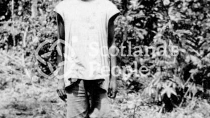Cameroonian in a clearing in the jungle with a camp fire Cameroonian in a clearing in the jungle with a camp fire