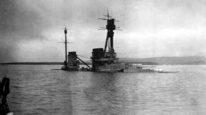 The German Derfflinger Class battlecruiser SMS Hindenburg half submerged at Scapa Flow after being scuttled on 21 June 1919