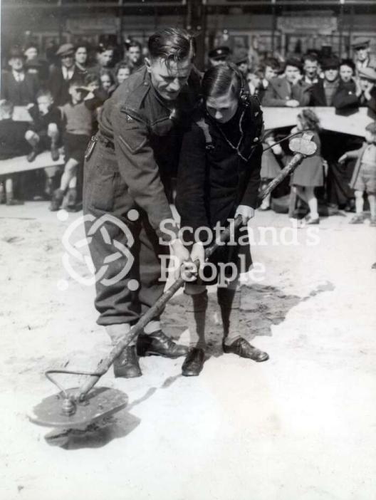 Soldier and boy with mine detector, 1944 Soldier and boy with mine detector, 1944