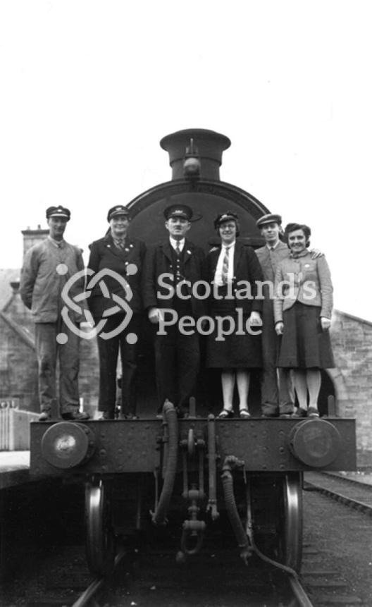 Railway staff on front footplate of locomotive, 1943