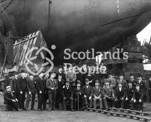 Staff of J & G Thomson posing before the bow of HMS Ramilies on the slip way on the day of the launch. Staff of J & G Thomson posing before the bow of HMS Ramilies on the slip way on the day of the launch.