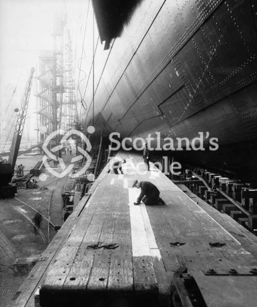 Workmen preparing the launching ways of the Cunard Line ocean liner Queen Mary Workmen preparing the launching ways of the Cunard Line ocean liner Queen Mary