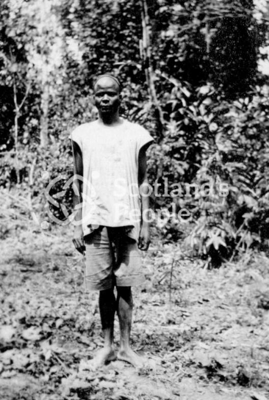Cameroonian in a clearing in the jungle with a camp fire Cameroonian in a clearing in the jungle with a camp fire
