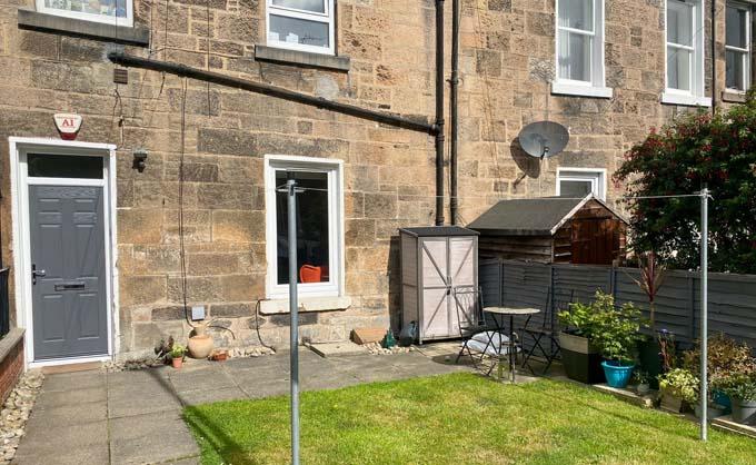 The front view of 12 Waverley Place. The upstairs floor is a separate residence and is accessed from the street behind, via a staircase. Credit: Crown copyright, National Records of Scotland. 