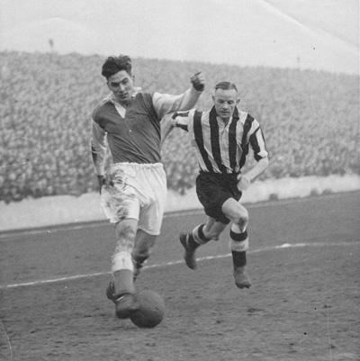 Gordon Smith (left) playing in a match against Partick Thistle at Easter Road. Credit: private collection.