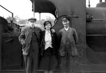 Photograph of railway staff beside locomotive