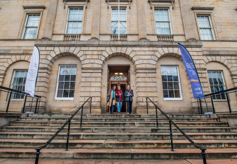 Three women walking down the steps of General Register House, Edinburgh