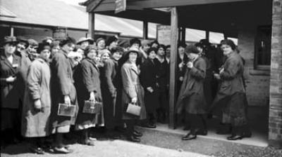 Photograph of female workers at the checking in point at HM Munitions Factory Gretna
