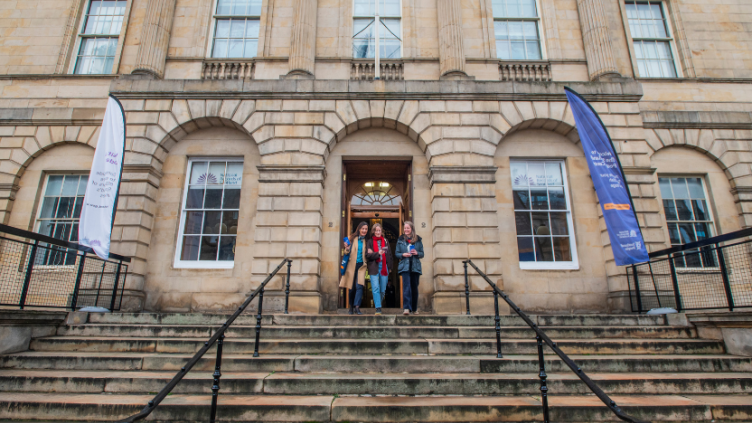 Three women walking down the steps of General Register House, Edinburgh