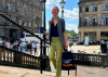 A woman walking up steps holding the Scotland's People navy tote bag in her hand.